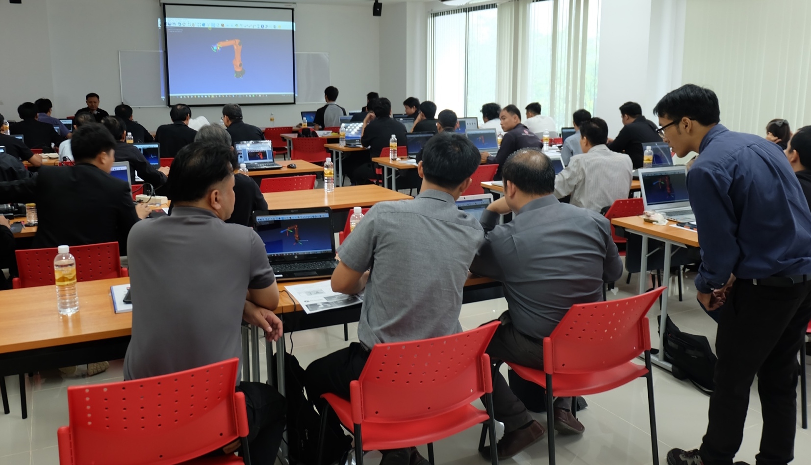 Class with people learning RoboDK